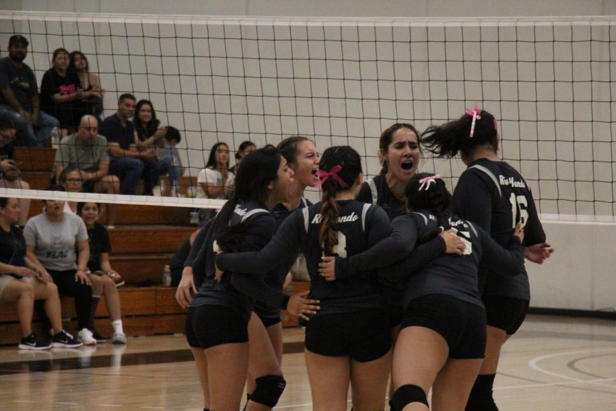 The team gets hyped up after a big play to continue their dominance in the match. With the crowd chanting and screaming, the team is feeding off that energy and getting excited themselves.