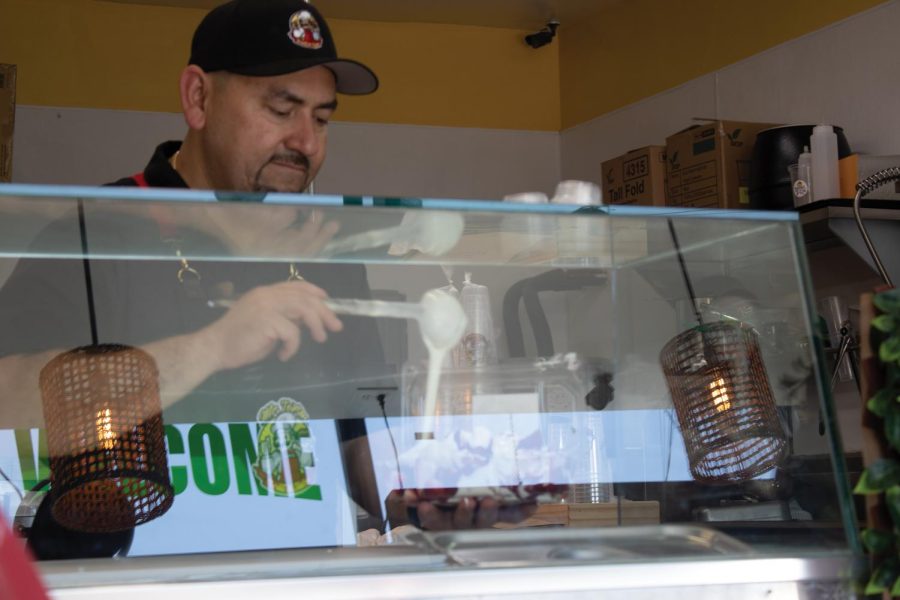 Sandro Magaña serves a multitude of hot and cold treats at his and his family's new shop in Huntington Beach. Calif.