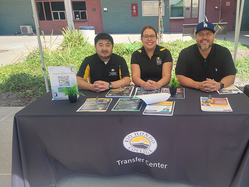 From left, Honors Transfer Counselor David Tieu, Transfer Counselor Delmis Alvarado, and Transfer Counselor Jose Lara sat at the Transfer Center 
information table to answer questions and provide transfer resources.