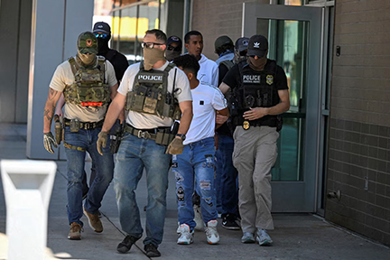 Law enforcement officers, including HSI and ICE agents, take people into custody at an immigration court in Phoenix, Arizona, U.S., May 21, 2025.